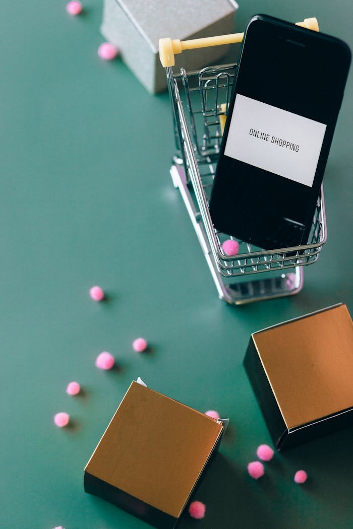 Smartphone in miniature shopping cart illustrating online shopping and ecommerce concept.